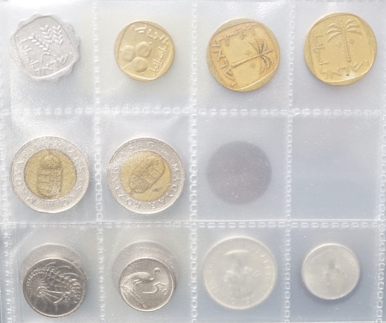 A stamp album, alphabetically mounted by country, mostly early 20th century, including some Commonwealth mounted mint, together with an album of mainly British coinage, 20th century, but includes two Roman AR denarius